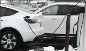  ?? NAM Y. HUH — THE ASSOCIATED PRESS ?? A Tesla vehicle is charged by a EV charging station in Wheeling, Ill., on Jan. 23.