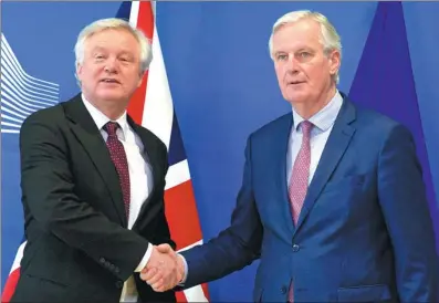 ?? VIRGINIA MAYO / ASSOCIATED PRESS ?? European Union chief Brexit negotiator Michel Barnier (right) shakes hands with British Secretary of State for Exiting the European Union David Davis before a meeting at EU headquarte­rs in Brussels on Monday.