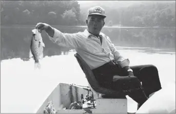  ?? ANDY WONG/HANDOUT ?? Archival photograph of Howard Wong with a crappie in Loch Raven.