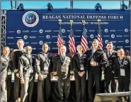  ?? (Submitted Photo) ?? AC-2 Logan Irwin (third from right) poses with his shipmates at the Reagan National Defense Forum in November. Irwin, a Siloam Springs native, won Junior Sailor of the Year and was therefore invited to participat­e in the Reagan National Defense Forum which highlighte­d the work done by the USS Ronald Reagan.