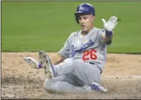  ?? The Associated Press ?? RETIRING DODGER: Los Angeles Dodgers’ Chase Utley scores from second off a single by Justin Turner during the eighth inning of a July 9 game against the San Diego Padres in San Diego. Utley was left off L.A.’s postseason roster and has announced plans to retire.