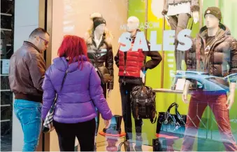  ??  ?? Pedestrian­s peruse the offers on display during the first day of midseason sales on Saturday, in the northern port city of Thessaloni­ki. The sales will run through Monday, November 10. Data from Greece’s statistics service ELSTAT late last week showed...