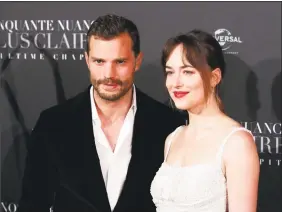  ?? Francois Mori / Associated Press ?? Jamie Dornan, left, and Dakota Johnson during a photocall for the world premiere of “Fifty Shades Freed” at Salle Pleyel in Paris.