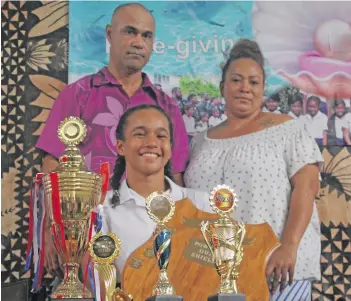  ??  ?? Charlize-Joy Smith with her parents James and Selaima Smith.