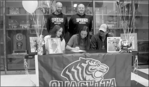  ?? Photo by Gerren Smith ?? THE SIGNEE: Poyen’s softball pitcher, Kodee Batchelor signs a National Letter of Intent to play softball at Ouachita Baptist University. Joining Batchelor is parents Shanna and Heath, Poyen head softball coach Blue Kesterson and assistant coach Keith Barrett Thursday during signing day held at the Jerry and Ouida Newton Arena in Poyen.