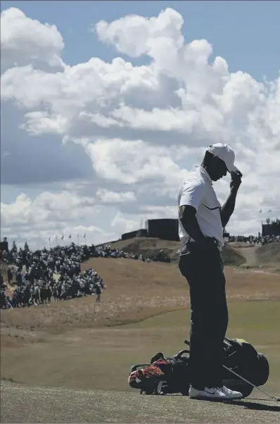  ??  ?? A pensive Tiger Woods waits to play a shot during the second round of the US Open at Chambers Bay