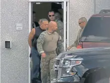  ?? WPLG-TV VIA AP ?? TRACKED DOWN: In a frame grab from video provided by WPLG-TV, FBI agents escort mail-bomb suspect Cesar Sayoc, in sleeveless shirt, in Miramar, Fla., on Friday.