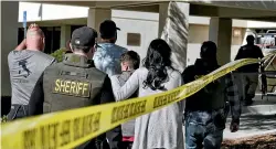  ?? AP ?? Family members are led into the Thousand Oaks Teen Centre where families have gathered after a deadly shooting at a bar on Thursday in Thousand Oaks, California.