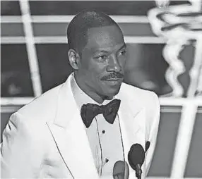  ??  ?? Eddie Murphy presents the award for best original screenplay in 2015 at the Oscars at the Dolby Theatre in Los Angeles. JOHN SHEARER / INVISION/ AP