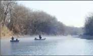  ?? NWA Democrat-Gazette/FLIP PUTTHOFF ?? One never knows when a fishing trip might become a great fish story. Anglers fish on the White River east of Fayettevil­le in March.