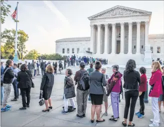  ?? AP PHOTO ?? People line up at the Supreme Court on the first day of the new term, on Capitol Hill in Washington, Monday. Amid the political chaos of Judge Brett Kavanaugh’s nomination, the high court’s work begins with only eight justices on the bench, four conservati­ves and four liberals.