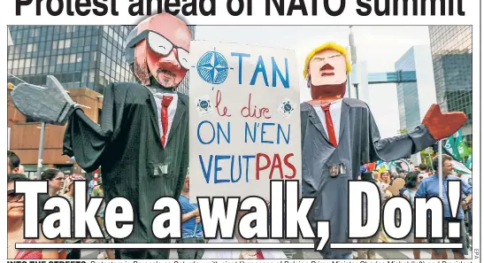  ??  ?? INTO THE STREETS: Protesters in Brussels on Saturday, with giant likenesses of Belgian Prime Minister Charles Michel (left) and President Trump, tell the soon-to-arrive US leader that he’s “not welcome.” Trump is due Tuesday in Brussels for the...