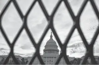  ?? J. Scott Applewhite / Associated Press ?? With authoritie­s warning of possible violence at a rally Saturday by far-right supporters of former President Donald Trump, security fencing has been reinstalle­d around the Capitol.