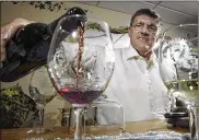  ?? CHRIS STEWART / FILE ?? James Brandeberr­y pours a glass of his cabernet sauvignon. The Wright State engineerin­g dean, who died Friday, also founded his own winery.