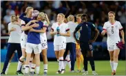  ?? MICHEL EULER AP PHOTO BY ?? United States’ Megan Rapinoe, back to camera, is embraced by teammates after the Women’s World Cup quarterfin­al soccer match between France and the United States at the Parc des Princes, in Paris, Friday, June 28. the U.S. won the match 2-1.