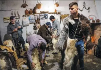  ?? ?? Men prepare themselves Jan. 20 before taking part in the “Las Carantonas” festival.