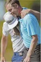  ?? AP PHOTO ?? TEAMWORK: Jonas Blixt (right) hugs Cameron Smith as they celebrate their playoff victory in the Zurich Classic yesterday.