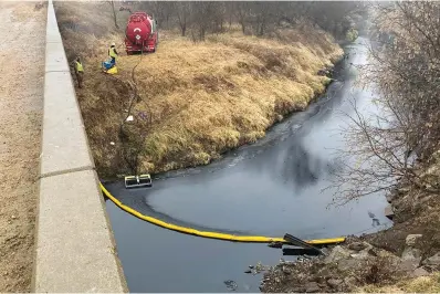  ?? The Associated Press ?? ■ A remediatio­n company deploys a boom on the surface of an oil spill Thursday after a Keystone pipeline ruptured at Mill Creek in Washington County, Kan. Vacuum trucks, booms and an emergency dam were constructe­d on the creek to intercept the spill.