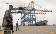  ?? — Reuters ?? A policeman stands guard at the DP World-managed Doraleh container terminal in Djibouti port.