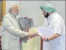  ?? PTI ?? Punjab chief minister Captain Amarinder Singh greeting Prime Minister Narendra Modi in New Delhi on Thursday.