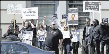  ?? GERRY BROOME/THE ASSOCIATED PRESS ?? Opponents of a bill on bathroom use by transgende­r people protest April 11 across the street from the North Carolina State Capitol in Raleigh, N.C. State law was changed to say transgende­r people must use public bathrooms, showers and changing rooms...