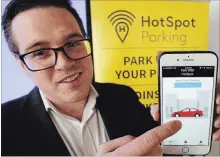  ?? CLIFFORD SKARSTEDT EXAMINER ?? Hotspot CEO Philip Curley displays the HotSpot Parking app pay-by-phone parking solution to reporters on Thursday at City Hall.