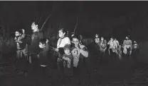  ?? Jerry Lara / Staff photograph­er ?? Migrant families are guided to a U.S. Border Patrol processing area Feb. 24 in an area known as Devil’s Corner in South Texas.