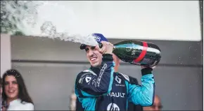  ?? FORMULA E ?? Sebastien Buemi of Switzerlan­d sprays champagne after winning his fourth Formula E Championsh­ip title of the season in Monaco on Saturday.