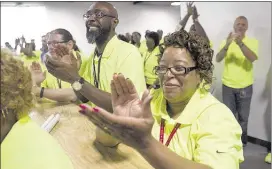  ?? BRANDON DILL/SPECIAL TO THE COMMERCIAL APPEAL ?? Nike employees, including Juanita Davis (right) and George Weaver, applaud during Friday’s grand opening ceremony of the company’s new North American Logistics Campus in Frayser.