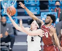  ?? AJ MAST/AP ?? Drew Timme beats Oklahoma’s Elijah Harkless for a layup during Gonzaga’s win Monday. Timme had a career-high 30 points.