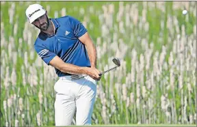  ?? Picture: AFP ?? DIFFICULT TASK: Dustin Johnson chips up to the first green during a practice round of the US Open