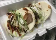  ?? (Arkansas Democrat-Gazette/Philip Martin) ?? Beijing Style Duck Lotus Bun as a takeout dish is visually appealing and flavorful.