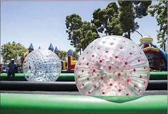  ?? FELIX ADAMO / THE CALIFORNIA­N / FILE ?? There will be plenty of free activities for children at Saturday’s East Bakersfiel­d Festival, like this inflatable race set-up seen at the 2018 event.