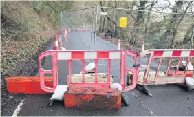  ??  ?? Work is being carried out on a stretch of road between the villages of Bronwydd and Llanpumsai­nt which was closed off after a landslide.