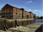  ?? PHOTOS: COLIN WAREING/COLIN AND CAROLE’S CREATIONS ?? Regenerati­on work on the warehouses. In the foreground is the modern representa­tion of the coal staithe that was there when the barges loaded with coal were brought from local mines by railway trucks.