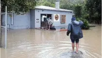  ?? ?? ASSESSING THE DAMAGE: Chris Gidana wades across to his firearms and ammunition shop, where his strongroom safes were ‘completely’ underwater.