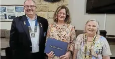  ?? ?? WELL DESERVED: Tori Stowe, centre, receives the Paul Harris award from the district governor.