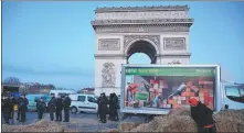  ?? REMON HAAZEN / GETTY IMAGES ?? Farmers block roads around the Arc de Triomphe, including the entry to Champs-Elysees, with tractors on Friday.