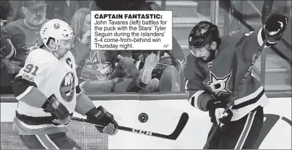  ?? AP ?? CAPTAIN FANTASTIC: John Tavares (left) battles for the puck with the Stars’ Tyler Seguin during the Islanders’ 5-4 come-from-behind win Thursday night.