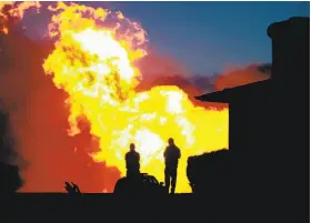  ?? Liz Hafalia / The Chronicle 2014 ?? Flames light the San Bruno sky after the 2010 blast that led to a PG&E penalty.