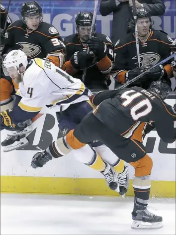  ?? Chris Carlson/Associated Press ?? Nashville defenseman Mattias Ekholm, left, is part of a unit that not only excels at keeping the puck out of goal, but provides a scoring punch, as well.