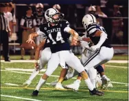  ?? David Stewart / Hearst Connecticu­t Media ?? Staples quarterbac­k Ryan Thompson drops back to pass against Trumbull on Friday in Westport.