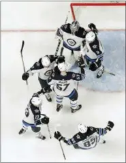  ?? MARK HUMPHREY — THE ASSOCIATED PRESS ?? Winnipeg Jets celebrate after defeating the Nashville Predators 5-1 in Game 7 of an NHL hockey second-round playoff series Thursday in Nashville, Tenn. The Jets advanced to the conference final.