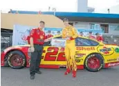  ?? SEAN GARDNER/GETTY IMAGES ?? Crew chief Todd Gordon and Joey Logano, driver of No. 22 Ford, celebrate winning the pole for Sunday’s race.