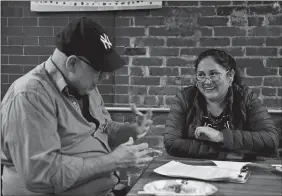  ?? SARAH GORDON/THE DAY ?? Carlos Canales of Norwich, originally from Puerto Rico, works with Lizbeth Polo-Smith of Groton, originally from Peru, on editing her narrative as part of an immigrant histories project in New London.