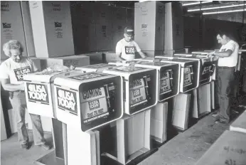  ?? USA TODAY ?? Coin racks are prepared for distributi­on before the first issue, a bargain at a quarter.