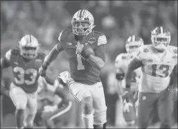  ?? Getty Images/tns ?? Quarterbac­k Justin Fields #1 of the Ohio State Buckeyes scrambles with the football during the Playstatio­n Fiesta Bowl against the Clemson Tigers at State Farm Stadium on December 28, 2019 in Glendale, Arizona.