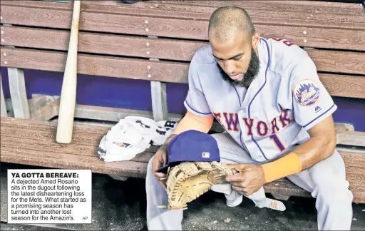  ?? AP ?? YA GOTTA BEREAVE: A dejected Amed Rosario sits in the dugout following the latest dishearten­ing loss for the Mets. What started as a promising season has turned into another lost season for the Amazin’s.
