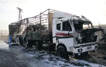  ?? OMAR HAJ KADOUR / AFP / GETTY IMAGES ?? A damaged truck is seen on the outskirts of the Syrian city of Aleppo Tuesday, the morning after a convoy delivering aid was hit by a deadly airstrike. The UN denounced what it called a deliberate attack, which killed 20 civilians.