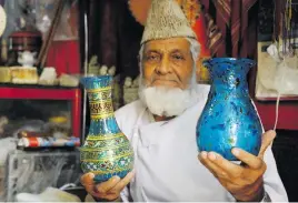  ??  ?? READY TO GO. Sultan Ahmad Hamidi, 78, sells Herati glassware at his handicraft­s shop in Afghanista­n.